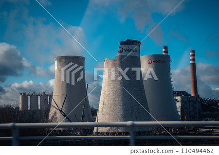 Building a nuclear power plant towers. Big chimneys beside road with partly cloudy sky. Building a nuclear power plant towers. Big chimneys beside road with partly cloudy sky. 110494462