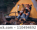 Man and boy tourists autumn time leisure, vacation hiking or traveling touristic activity. Family camping, father and little son relax in forest camp. 110494692