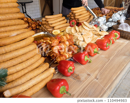 Street food, traditional polish sheep cheese, a lot of oscypki, sausages and shish kebab. Local tasty food for grill 110494983