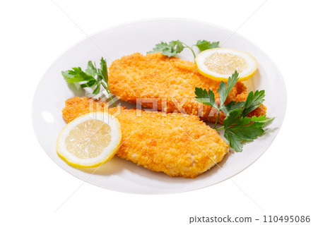 plate of chicken schnitzel on white background 110495086