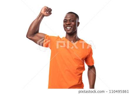 young american man dressed in orange corporate t-shirt experiencing joy and fun young american man dressed in orange corporate t-shirt experiencing joy and fun 110495861