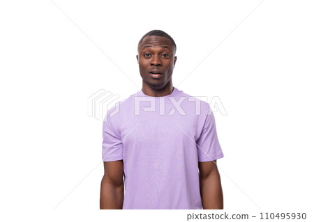 young surprised american guy dressed in a cotton t-shirt on a white background with copy space young surprised american guy dressed in a cotton t-shirt on a white background with copy space 110495930
