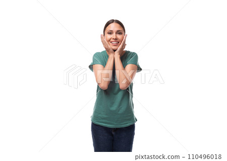 young black-haired woman in a green basic t-shirt with surprise tells the news 110496018