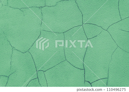 Old stucco plaster surface with cracks, green plaster wall background 110496275