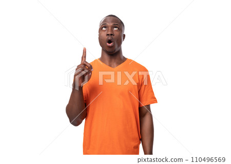 young inspired smart african man dressed in orange t-shirt tells the news 110496569