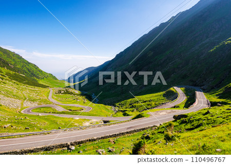 transfagarasan road winding through the green valley. beautiful landscape of fagaras mountains of romania in summer. popular travel destination of europe 110496767