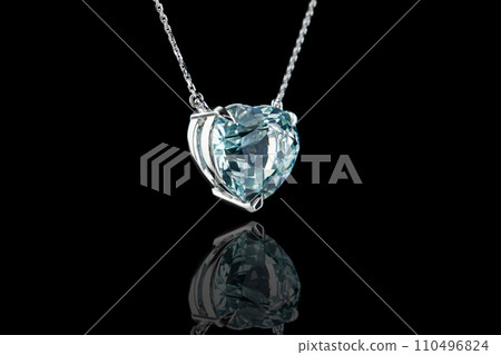 beautiful pendant with aquamarine with a gold chain on a black background 110496824