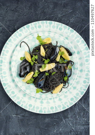 Black pasta with mussels and corn. Black pasta with mussels and corn. 110497627