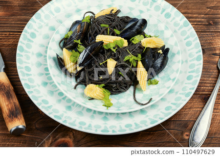 Black spaghetti pasta linguine with clams. 110497629