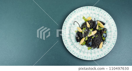 Black pasta with mussels and corn. 110497630