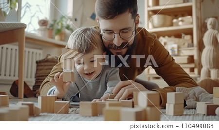 father and son building towers together while playing 110499083