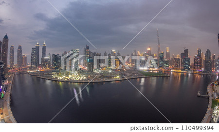 Aerial view to Dubai Business Bay and Downtown with the various skyscrapers and towers day to night timelapse Aerial view to Dubai Business Bay and Downtown with the various skyscrapers and towers day to night timelapse 110499394