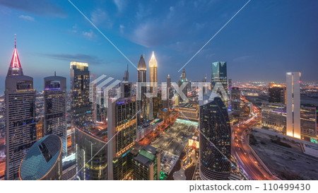 Skyline view of the high-rise buildings on Sheikh Zayed Road in Dubai aerial day to night timelapse, UAE. Skyline view of the high-rise buildings on Sheikh Zayed Road in Dubai aerial day to night timelapse, UAE. 110499430