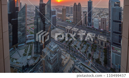 High-rise buildings on Sheikh Zayed Road in Dubai aerial timelapse during sunset, UAE. 110499437