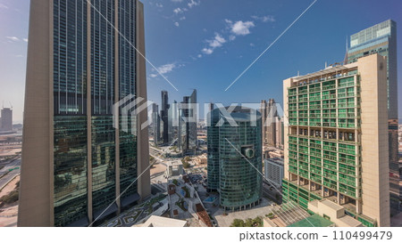 Dubai international financial center skyscrapers with promenade on a gate avenue aerial all day timelapse. 110499479