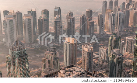 JLT skyscrapers and marina towers near Sheikh Zayed Road aerial timelapse during sunrise. Residential buildings JLT skyscrapers and marina towers near Sheikh Zayed Road aerial timelapse during sunrise. Residential buildings 110499480