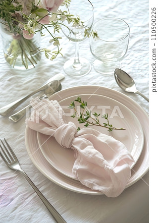 Sophisticated table setting with elegant dinnerware and a floral touch. Suitable for dining decor inspiration. AI Generated. 110500226