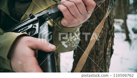 Usa Soldier reloading Old Thompson Sub-machine Gun. Close-up View Detail On Thompson Sub-machine Gun In Hands Of Re-enactor Dressed As American Infantry Soldier. Usa Army Soldiers Of World War Ii 110500762