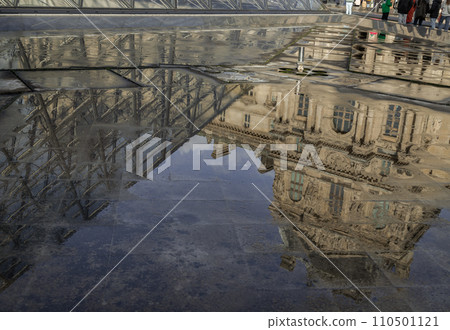 View of The historical palace building in water reflection effect by after raining at the front of Louvre pyramid. 110501121