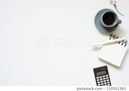 Workspace. black calculator, notepad, pen, cup of coffee on white desk background. flat lay, top view 110501363
