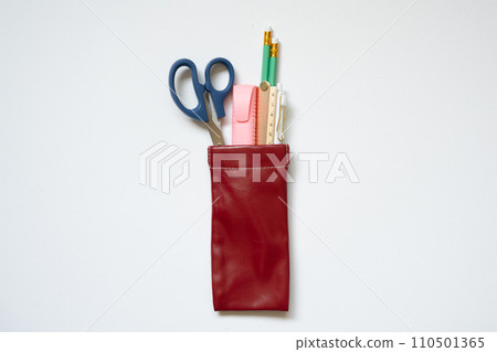 Writing supply. Pencil, pen, ruler, highlighter, scissors in pencil case isolated on white desk background. top view 110501365