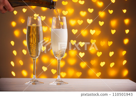beautiful glasses of champagne on a blurred background of hearts 110501943