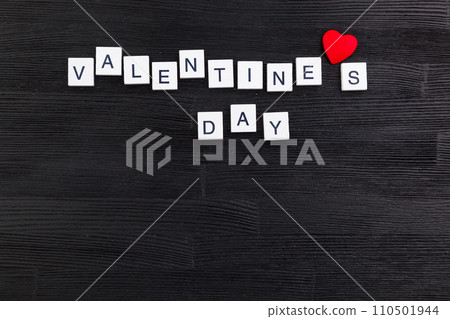 inscription Valentines day on a black wooden background inscription Valentines day on a black wooden background 110501944