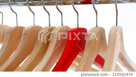Red and wooden hanger hanging on metal 110502474