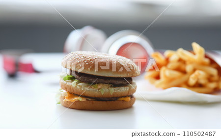 Hamburger and french fries with headphones 110502487