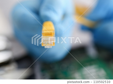 A male hand in blue protective gloves holds A male hand in blue protective gloves holds 110502510