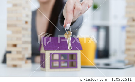 Female hand holds the key to the lock in Female hand holds the key to the lock in 110502511