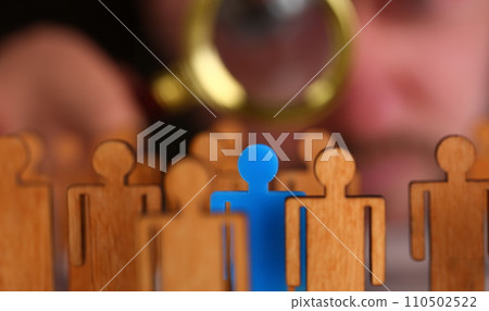 Man in suit look thru loupe on statuettes closeup 110502522