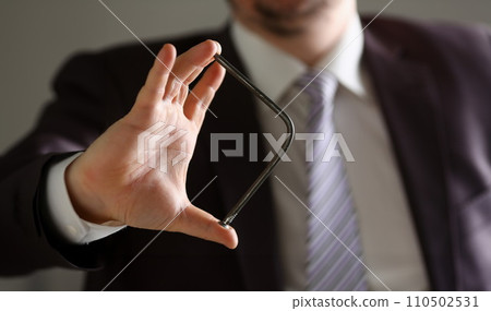 Man in suit and tie bend nail with arms closeup Man in suit and tie bend nail with arms closeup 110502531