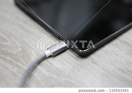 Smartphone being charged 110503301