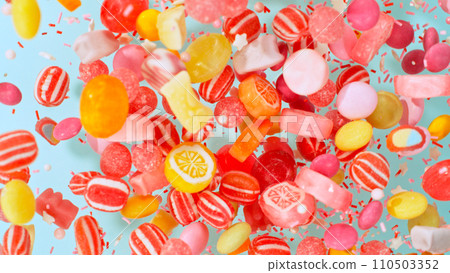Freeze motion of flying various kind of candies. Colored abstract sweet background. 110503352