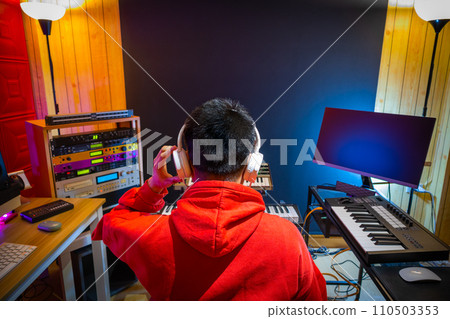 back of asian male music producer, composer, musician arranging a hit song in home studio. music production concept back of asian male music producer, composer, musician arranging a hit song in home studio. music production concept 110503353