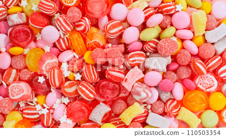 Freeze motion of flying various kind of candies. Colored abstract sweet background. Freeze motion of flying various kind of candies. Colored abstract sweet background. 110503354