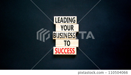 Leading your business to success symbol. Concept words Leading your business to success on wooden blocks. Beautiful black table black background. Leading your business to success concept. Copy space. 110504066
