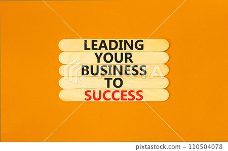 Leading your business to success symbol. Concept words Leading your business to success on wooden stick. Beautiful orange table orange background. Leading your business to success concept. Copy space. Leading your business to success symbol. Concept words Leading your business to success on wooden stick. Beautiful orange table orange background. Leading your business to success concept. Copy space. 110504078