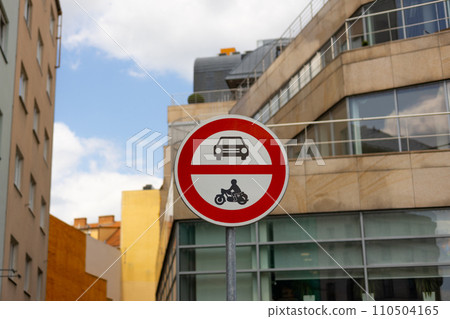 Road sign showing no entry for cars or motorcycles. Traffic sign has circle shape and is red and white with pictograms of automobile and motorbike. 110504165