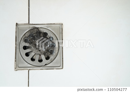 Close-up Pile of hair loss in bathroom after wash hair.hair fall everyday serious problem, on white background.Solutions for hair loss 110504277