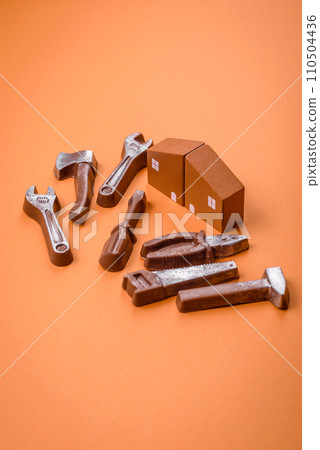 Repair or home improvement tools and a house model on a plain background Repair or home improvement tools and a house model on a plain background 110504436