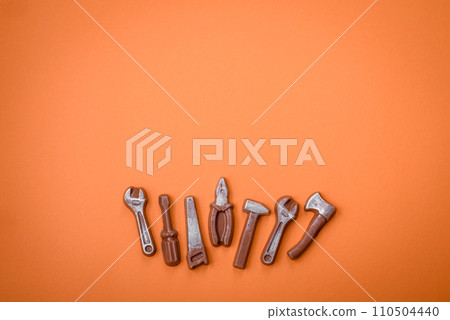 Tools and inscriptions symbolizing repairs or a garage and its attributes on a plain background Tools and inscriptions symbolizing repairs or a garage and its attributes on a plain background 110504440