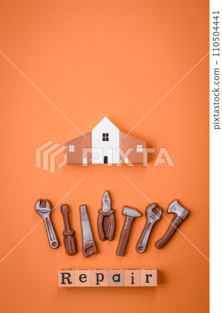 Repair or home improvement tools and a house model on a plain background 110504441