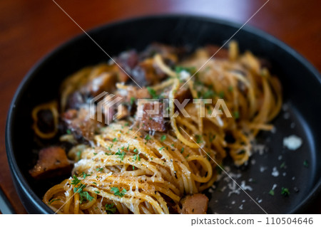 Spaghetti smoked pork with parmesqan cheese served on plate 110504646