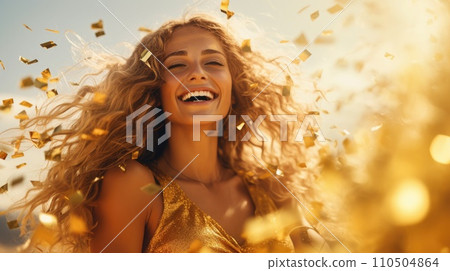 A woman with curly hair and gold confetti falling in the air 110504864