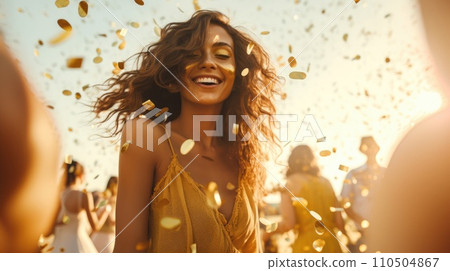 A woman with curly hair and gold confetti falling in the air A woman with curly hair and gold confetti falling in the air 110504867