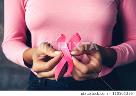 Pink ribbon held in female hands. Symbol of the fight against breast cancer Pink ribbon held in female hands. Symbol of the fight against breast cancer 110505356