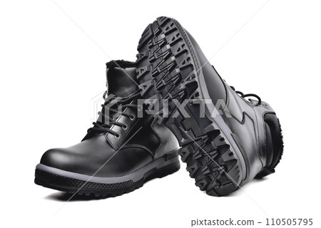 Winter  black leather boots on a white background, hiking shoes, practical off-road shoes, close-up 110505795
