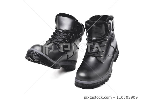 Winter  black leather boots on a white background, hiking shoes, practical off-road shoes, close-up 110505909